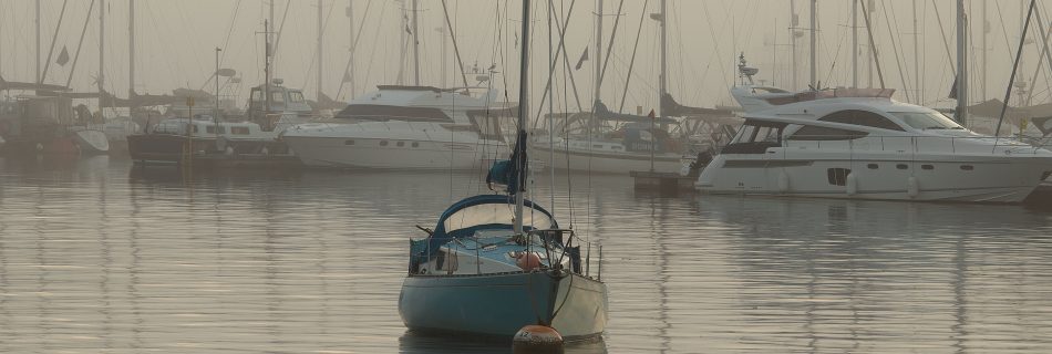 blue_yacht_in_mist_mayflower_marina_plymouth