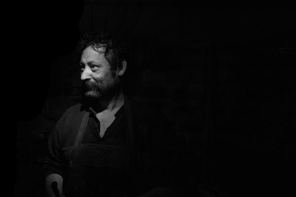 portrait_of_a_roma_blacksmith-standing_in_his_workshop