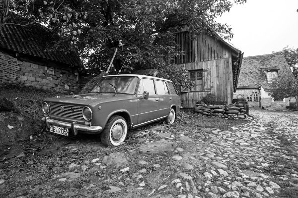 Vintage_Lada_2102_Soviet-era_station_wagon_parked_in_a_rustic_rural_setting