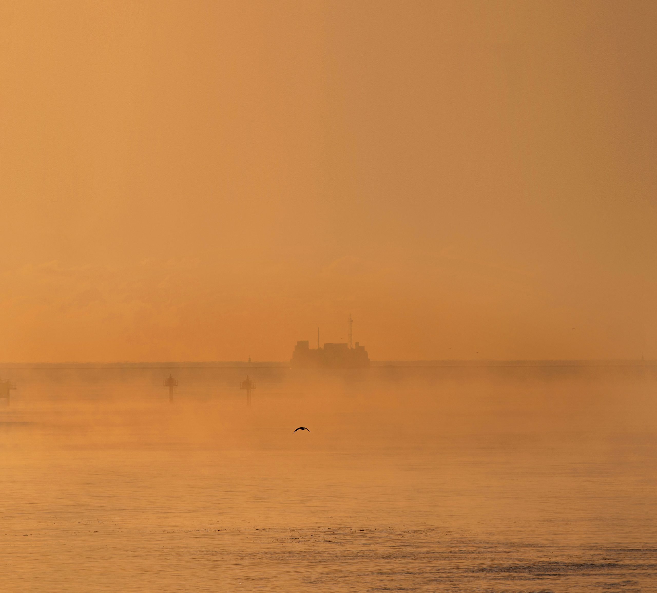 Plymouth Breakwater South in early morning sea mist with calm water and soft light in Plymouth Sound