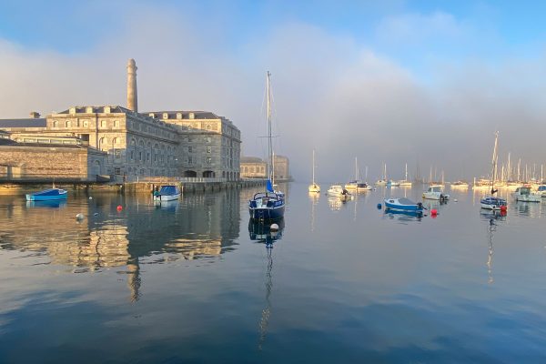 Early_morning_sea_fog_over_Hamoaze_waterway_in_Plymouth_with_Royal_William_Yard_emerging_in_soft_sunrise_light