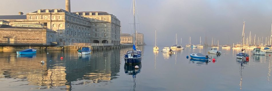 Early_morning_sea_fog_over_Hamoaze_waterway_in_Plymouth_with_Royal_William_Yard_emerging_in_soft_sunrise_light