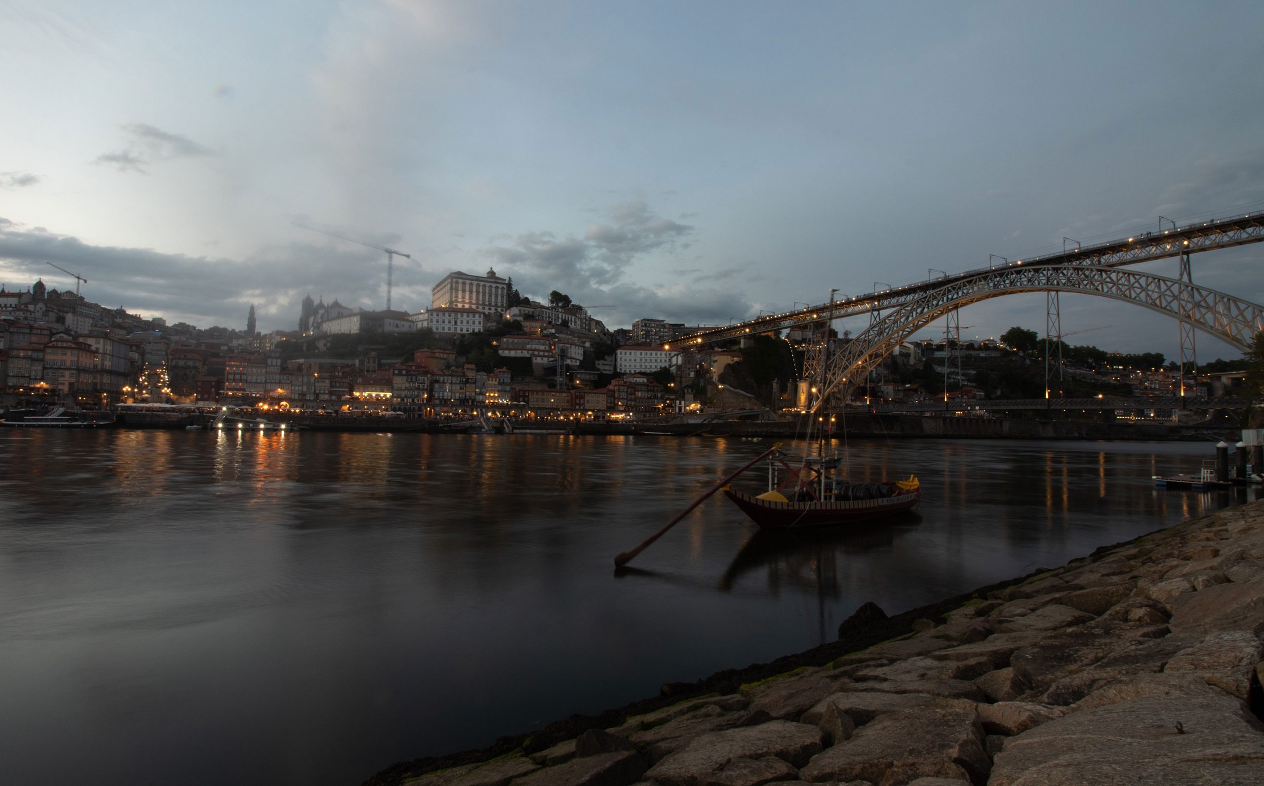 Traditional_rabelo_boat_moored_on_the_Douro_River_as_sun_begins_to_set